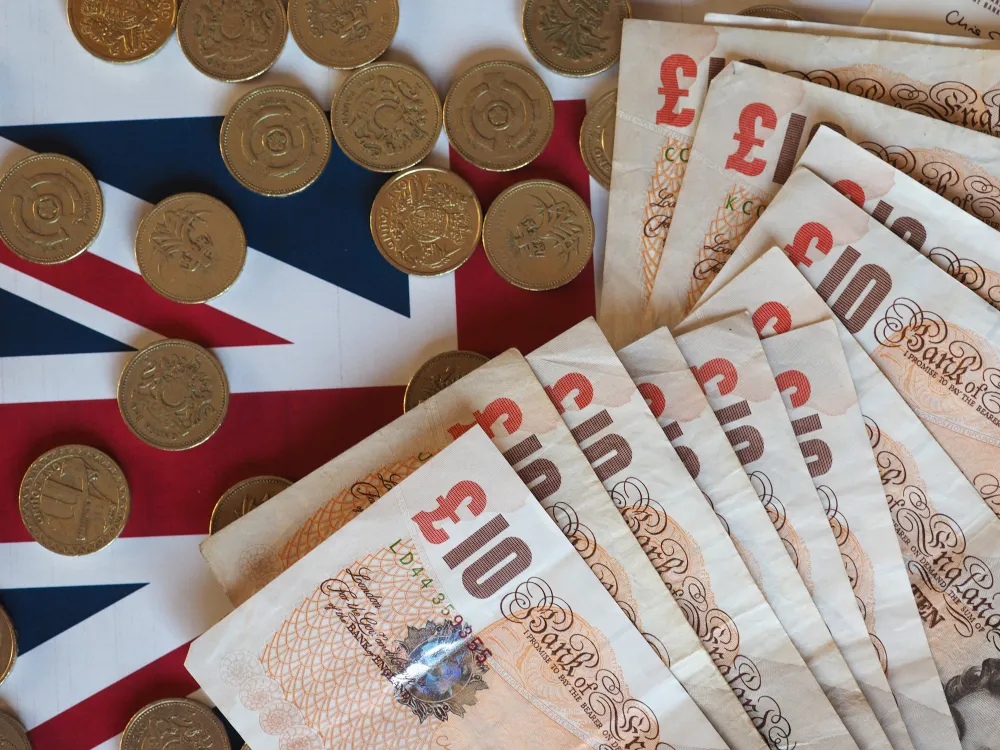 British pounds coins and Union Jack flag