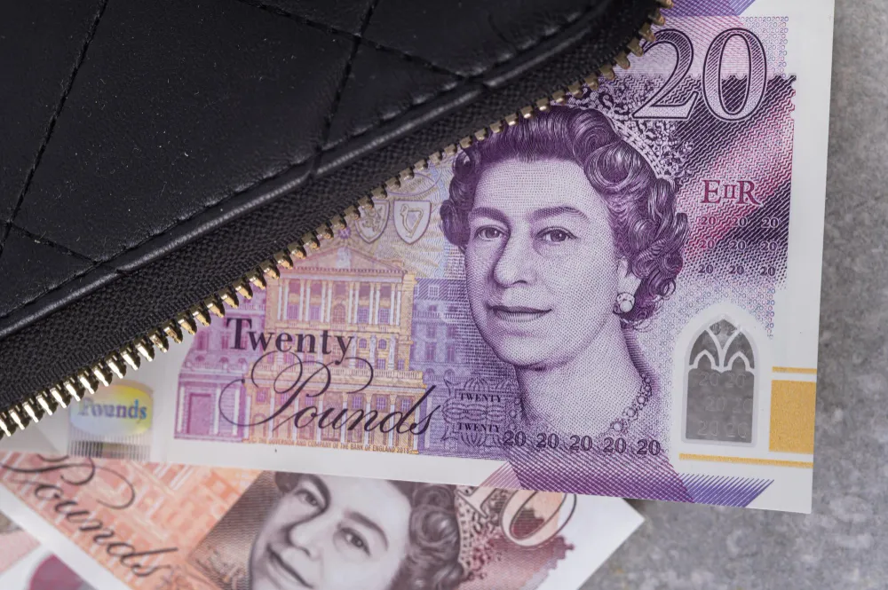 Twenty pound note and black wallet