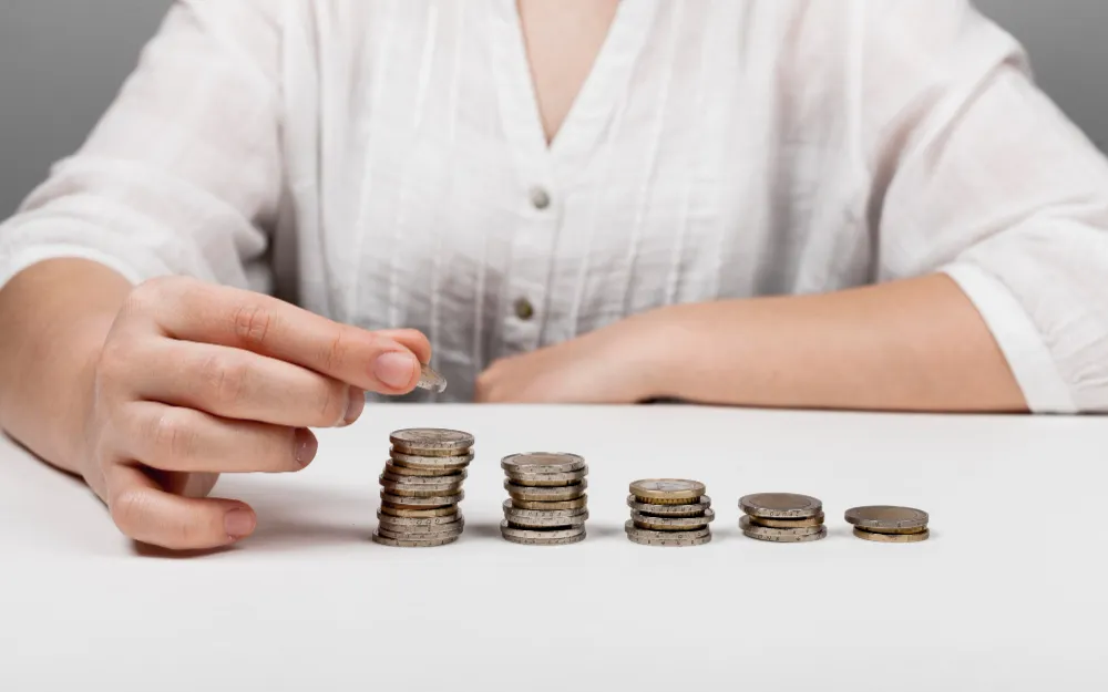 Woman counting coin stacks